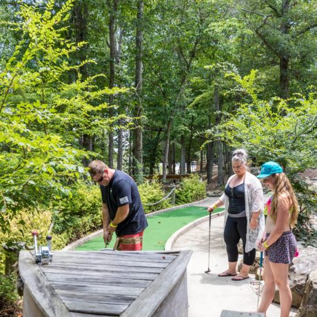 people putting on a mini golf course