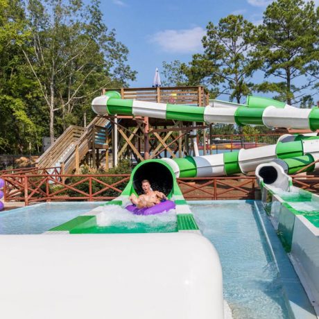 striped water slides with a person emerging