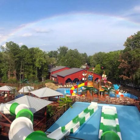 rainbow over the trees at pirates bay waterpark